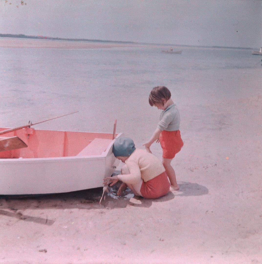 Artwork (Rosemary and unidentified small girl playing on the sand near a boat) this artwork made of Cellulose acetate Dufay colour transparency (originally in a glass mount), created in 1935-01-01