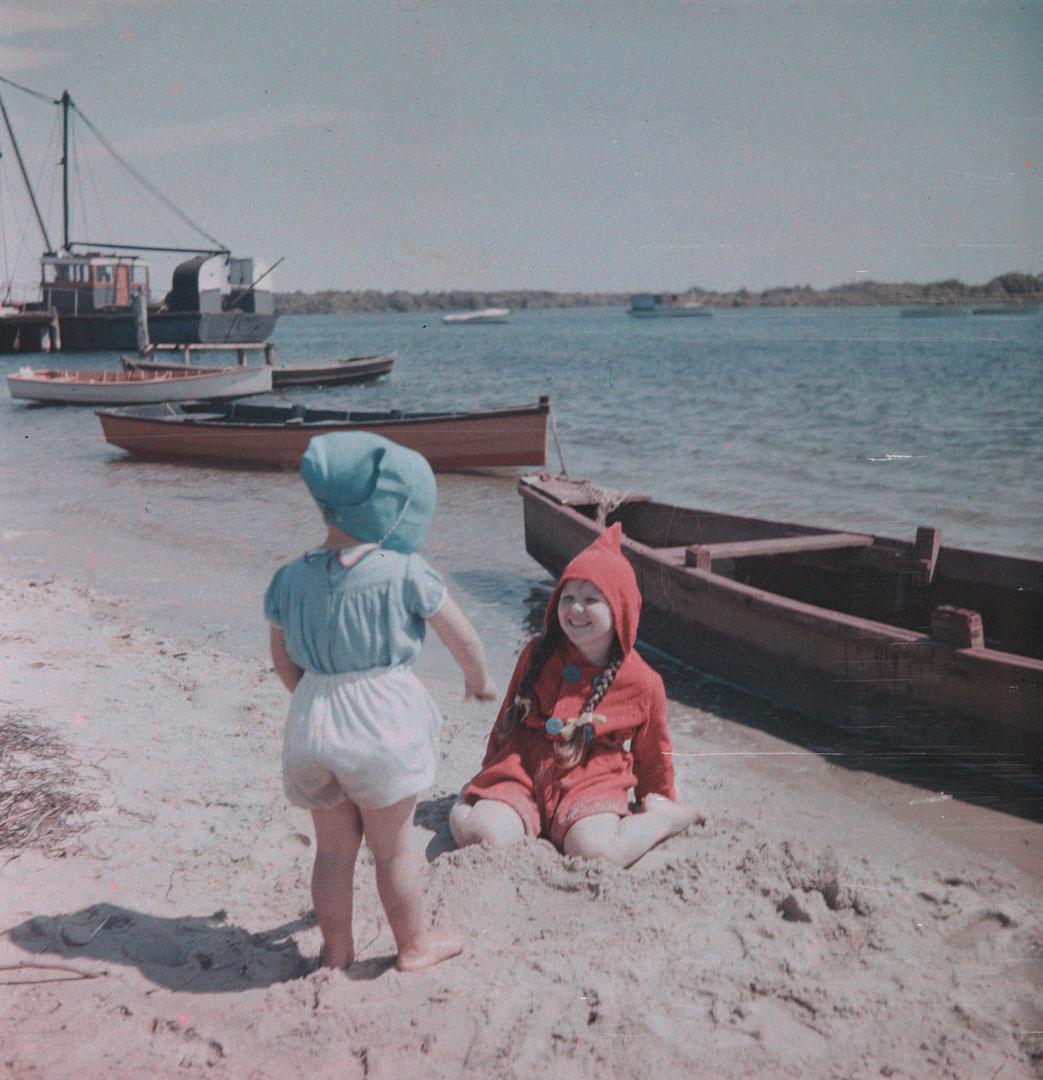 Artwork (Rosemary in a red coat with unidentified small girl on the sand) this artwork made of Cellulose acetate Dufay colour transparency (originally in a glass mount)
