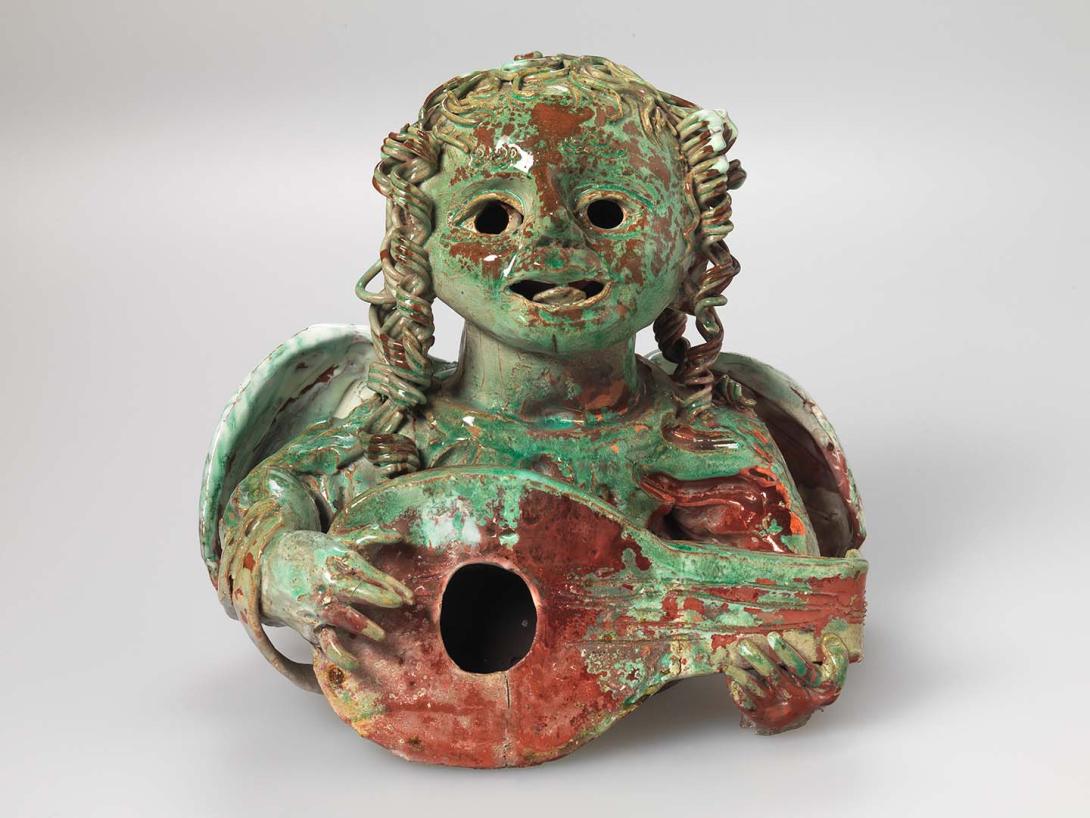 Artwork Sculpture: The Herald Angel this artwork made of Stoneware, bust of an angel playing a lute with green and red reduced copper glazes
