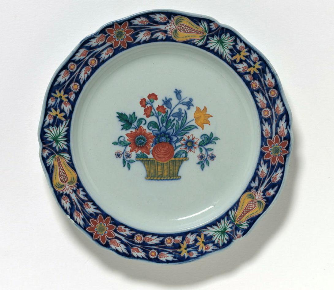 Artwork Pair of plates this artwork made of Stone china printed with a stylised floral motif in red and cobalt hand coloured in green and yellow with additional blue ground to the rim, created in 1925-01-01