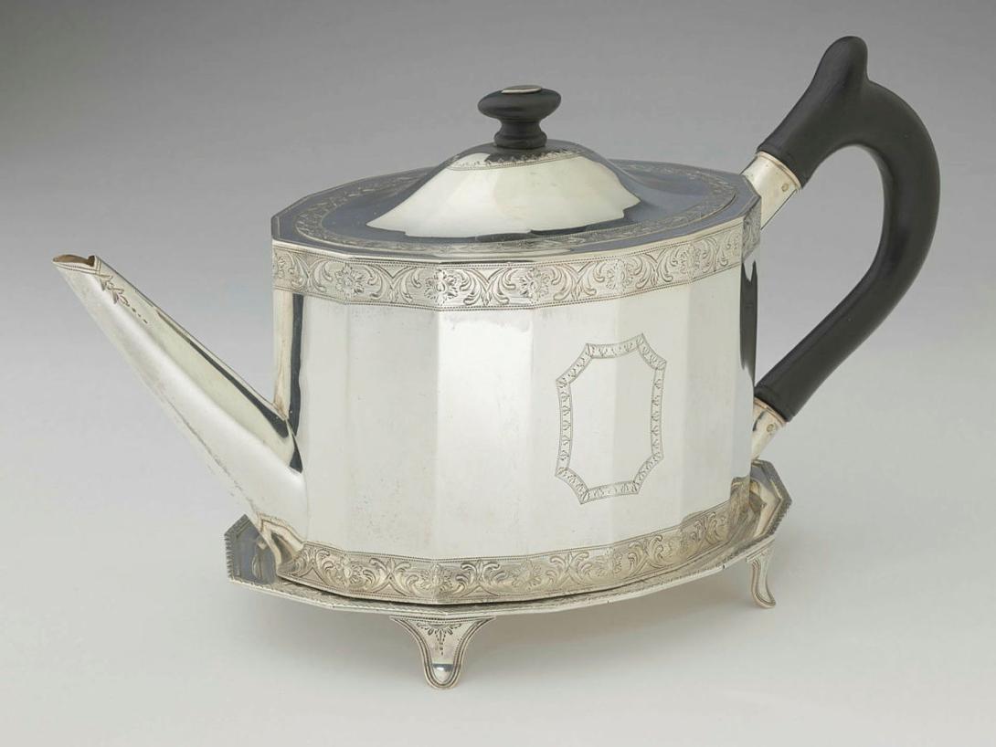 Artwork Teapot and stand this artwork made of Silver facetted sides engraved with a band of foliate motif top and bottom with wooden handle and lid;  silver stand with four curved flat feet, created in 1790-01-01