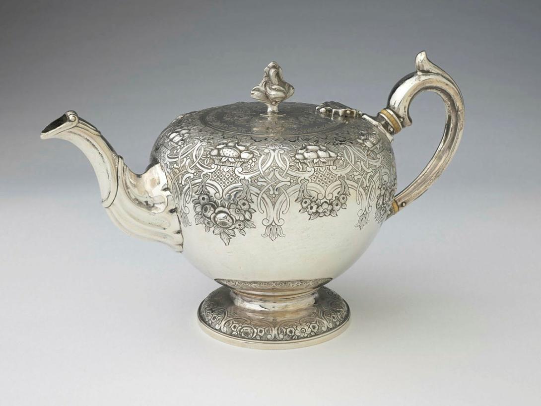 Artwork Teapot this artwork made of Silver, bullet shaped, with foliate knob, embossed with floral swags and engraved with scrolls and crest of the Ivory family.  Bone inset in handle, created in 1781-01-01