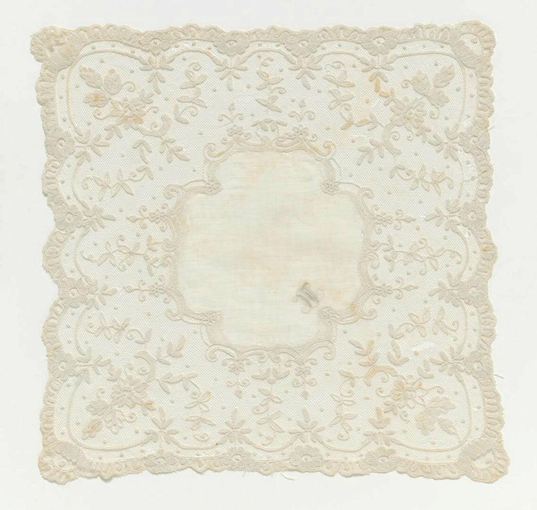 Artwork Handkerchief this artwork made of Liers lace:  machine made net, chain stitched with a tambour hook, created in 1800-01-01