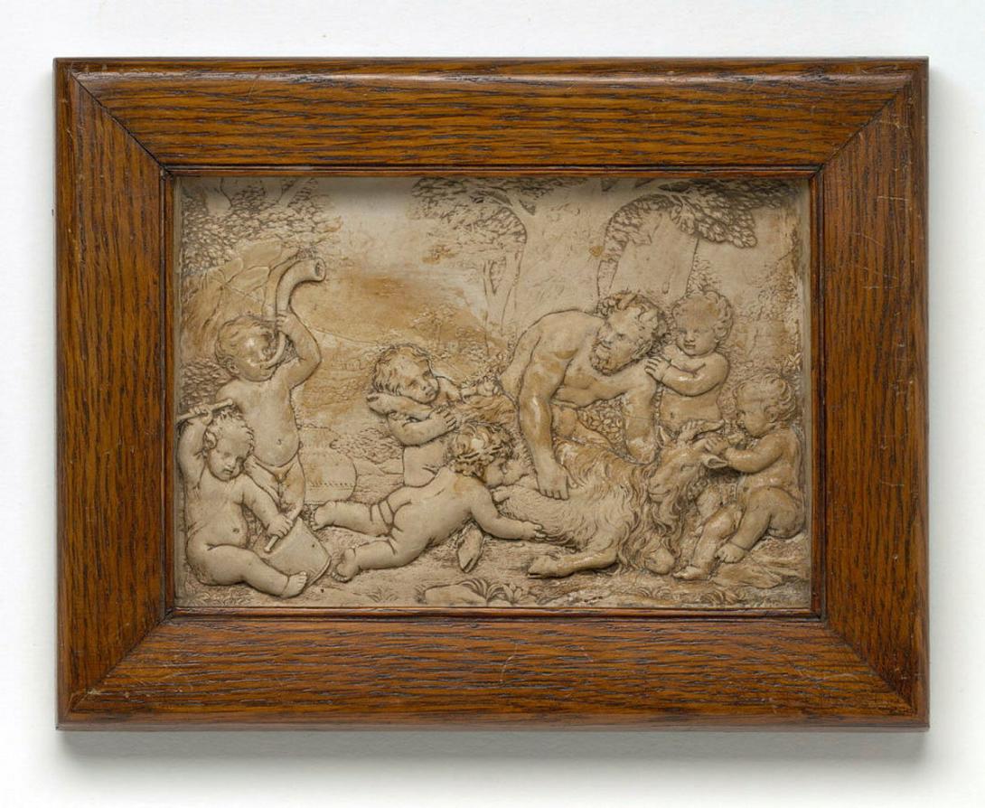 Artwork Plaque (copy of Roman?) this artwork made of Earthenware (terracotta) with figurative scene of a satyr holding a goat and feeding a child