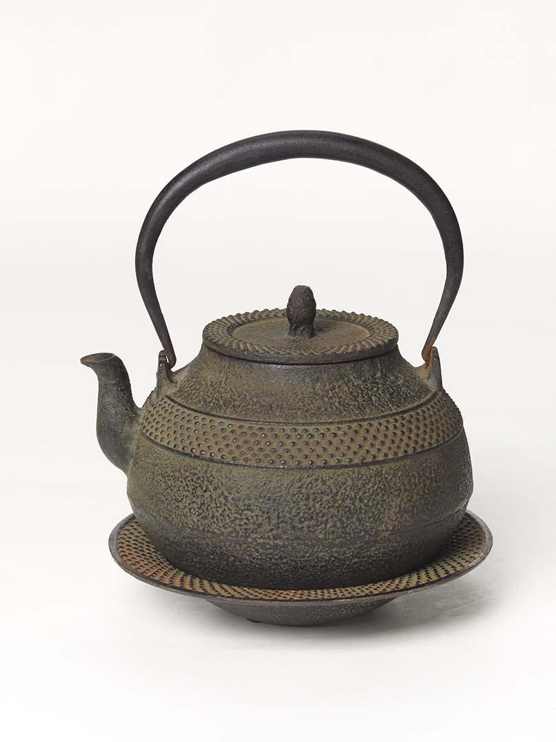 Artwork Tea-kettle and stand this artwork made of Black cast iron flattened spherical form decorated with bands of raised dots