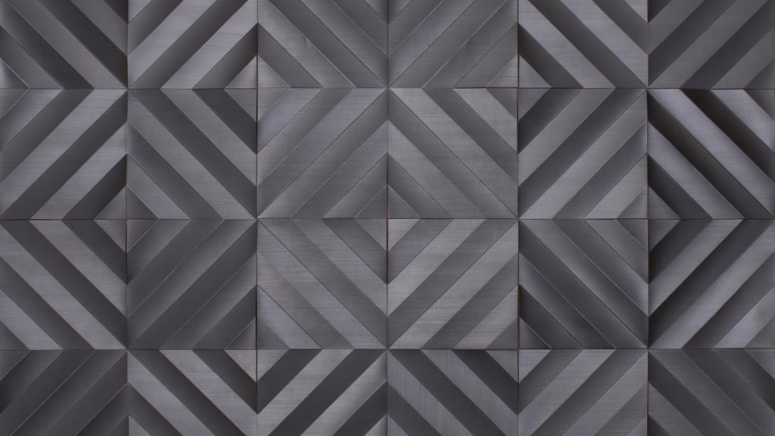 A graphite-on-paper work that looks like geometric patterns on metallic tiles.