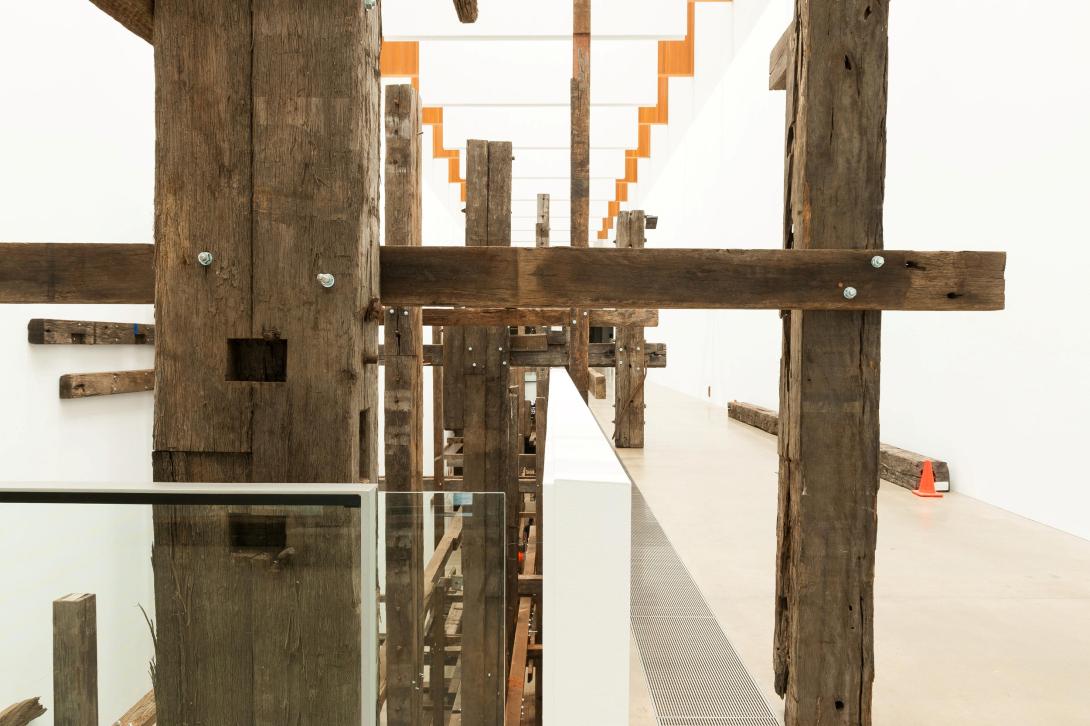 An installation made of large wooden beams built into GOMA's Long Gallery.