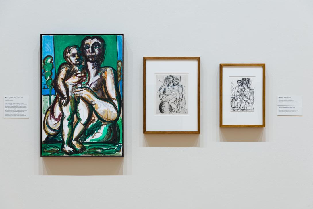 An installation view of three works: a large, painted work of the Madonna and child with a bright green-blue background, and two smaller ink works on the same theme.